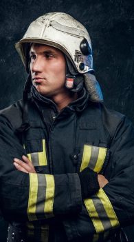 manly-firefighter-helmet-looks-sideways-studio-black-background_613910-20271
